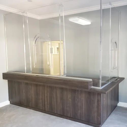 A desk outfitted with ballistic paneling that is functional and designed specifically for the space