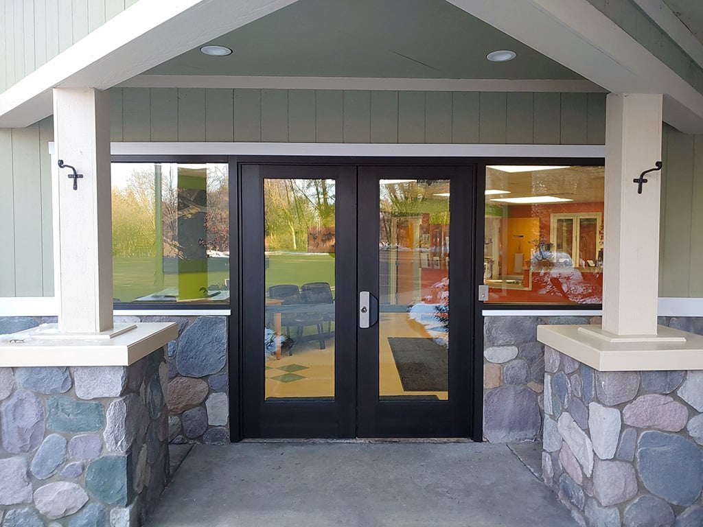 A photo displaying a school entrance that can be outfitted with ballistic and forced-entry protection, with the option for impact-resistant insulated units
