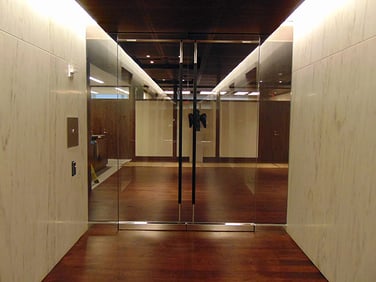 A photo showcasing glass double doors that deliver the right level of ballistic protection for a company and its occupants, alongside high-security entry doors and security windows for connected