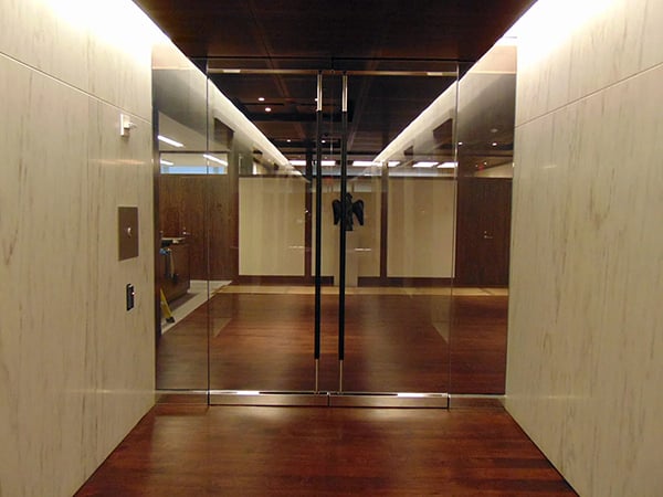 A photo showcasing glass double doors that deliver the right level of ballistic protection for a company and its occupants, alongside high-security entry doors and security windows for connected protection