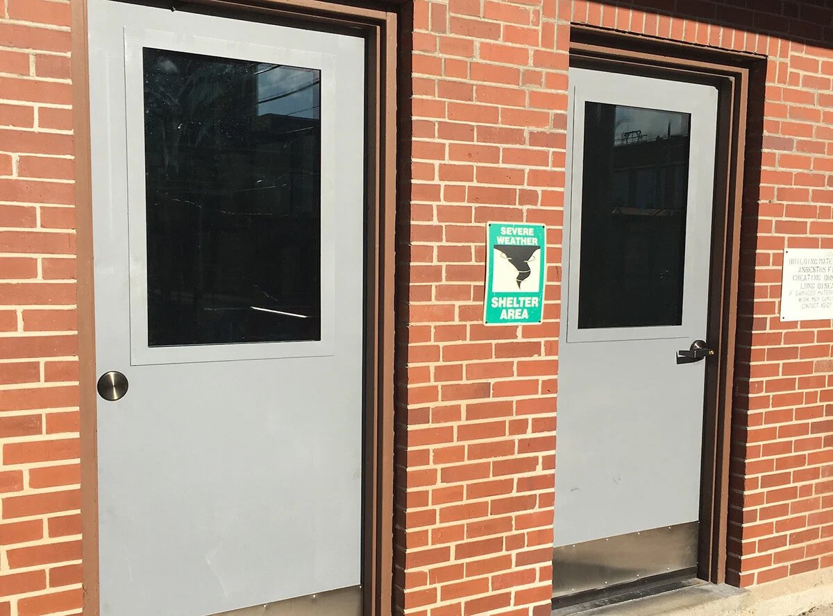 A photo showing commercial security door systems, specifically bullet proof steel doors, installed by Total Security Solutions, providing the benefit of ballistic protection within the structure