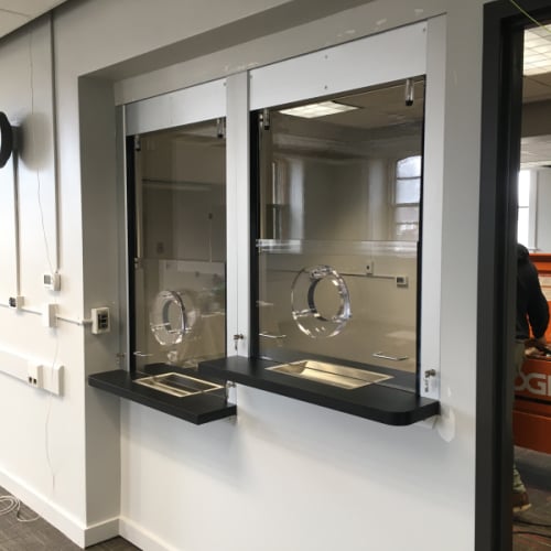 A teller counter outfitted with bulletproof wall panels tested to the appropriate level and built to handle high-impact force