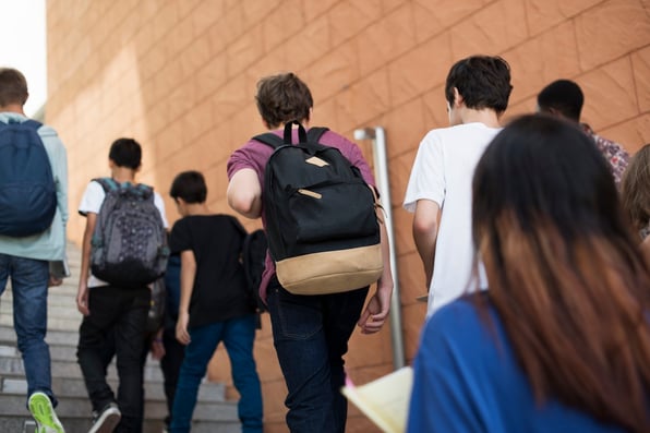 Students walk up the stairs in their middle school, illustrating the importance of ALICE active shooter training and other protocols.