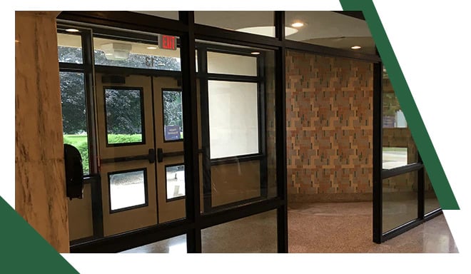 An example of bullet proof doors and bulletproof windows designed for and installed in the context of a school entrance as part of broader safety upgrades, eliminating the need for locking doors during school hours
