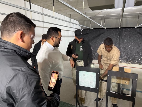 Members of the Presidential Protective Services For a Central American country prepare for a demonstration of bullet-resistant barrier systems.