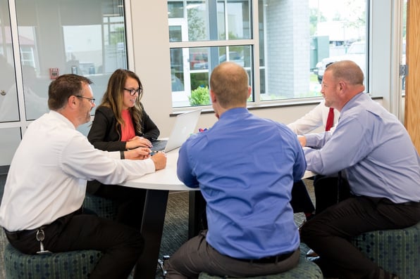 A group of employees collaborating, demonstrating the importance of physical security in the workplace.