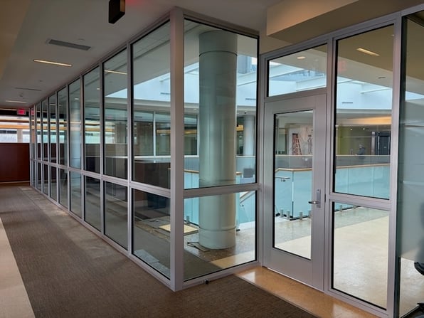 Ballistic glass windows and doors in a corporate building, showcasing the challenges of multi-site security. 