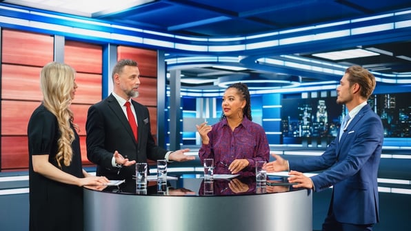 A group of TV anchors discusses the news of the day, illustrating the importance of physical security for media companies.