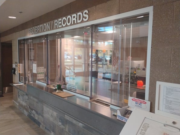 A photo of a reception area for a sheriff's office, demonstrating police station security