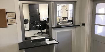 municipal teller window with metal deal tray
