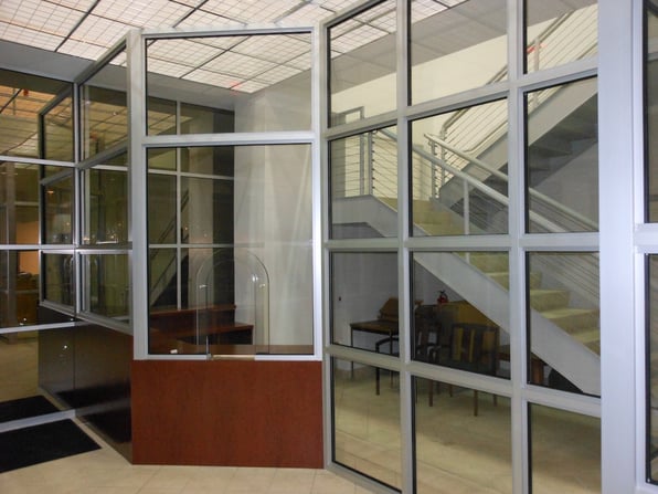Bulletproof glass at a corporate building illustrates the response to increases in workplace violence and protection strategies, including physical security. 
