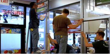 men handling clear glass